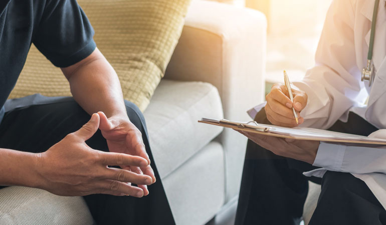 Doctor Taking Notes From Patient